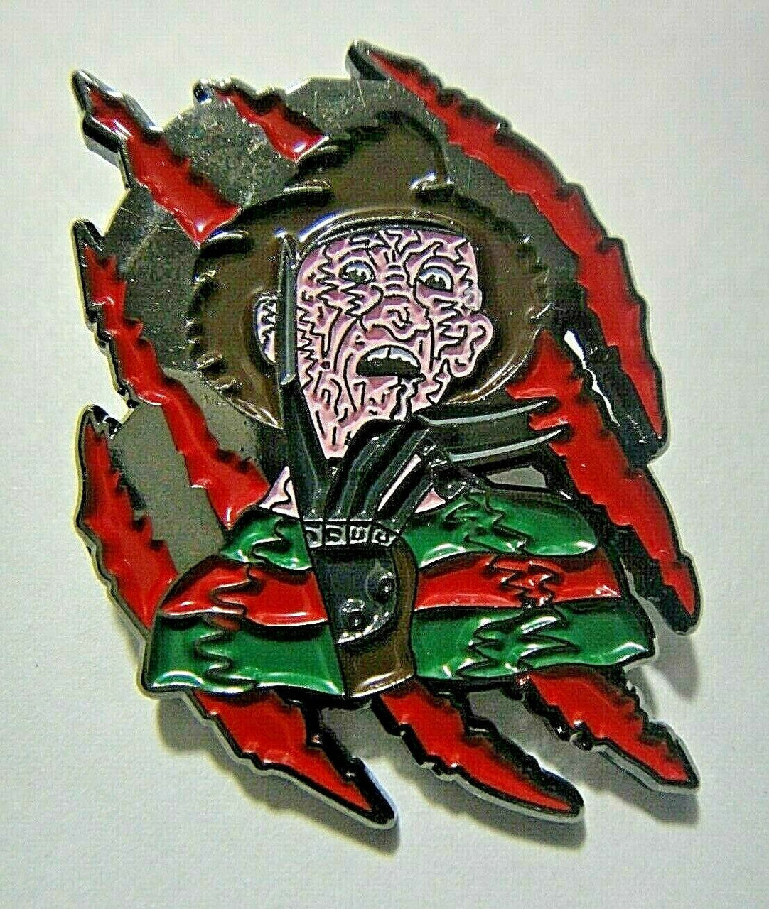 1 5/8" inches tall, a new Nightmare on Elm Street "Freddy" enamel pin with a metal post and rubber back. New.
Please note we will always combine shipping on like items. Any additional patch or pin will ship for 50 cent per item. Any additional payment will be reimbursed to your Paypal account. Thank You.