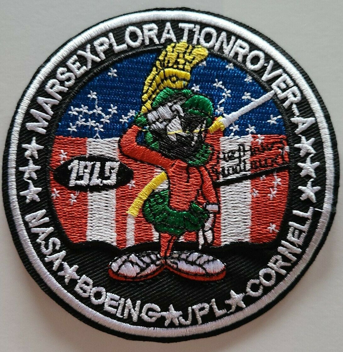 4 inches in diameter, a new Marvin The Martian Mars Exploration Rover NASA Boeing JPL Cornell Space embroidered 
patch. Sew on or iron on. New.

Please note we will always combine shipping on like items.  Any additional patch or pin will ship for 50 cent per item.  Any additional payment will be reimbursed to your Paypal account.  Thank You.