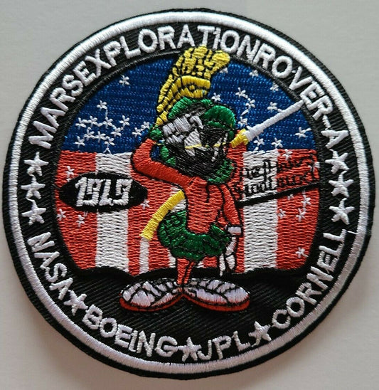 4 inches in diameter, a new Marvin The Martian Mars Exploration Rover NASA Boeing JPL Cornell Space embroidered 
patch. Sew on or iron on. New.

Please note we will always combine shipping on like items.  Any additional patch or pin will ship for 50 cent per item.  Any additional payment will be reimbursed to your Paypal account.  Thank You.