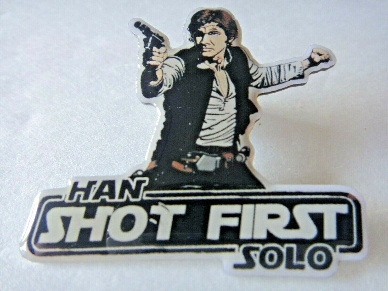 1.5 inches wide, Star Wars Hans Solo Shot First metal photo pin with clutch back. New.

Please note we will always combine shipping on like items.  Any additional patch or pin will ship for 50 cent per item.  Any additional payment will be reimbursed to your Paypal account.  Thank You.