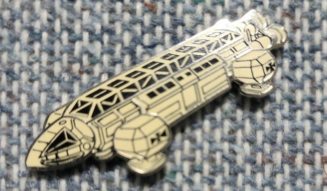 1 1/2 inches wide, a new Space 1999 Transport Ship enamel pin with clutch back. New.

Please note we will always combine shipping on like items.  Any additional patch or pin will ship for 50 cent per item.  Any additional payment will be reimbursed to your Paypal account.  Thank You.