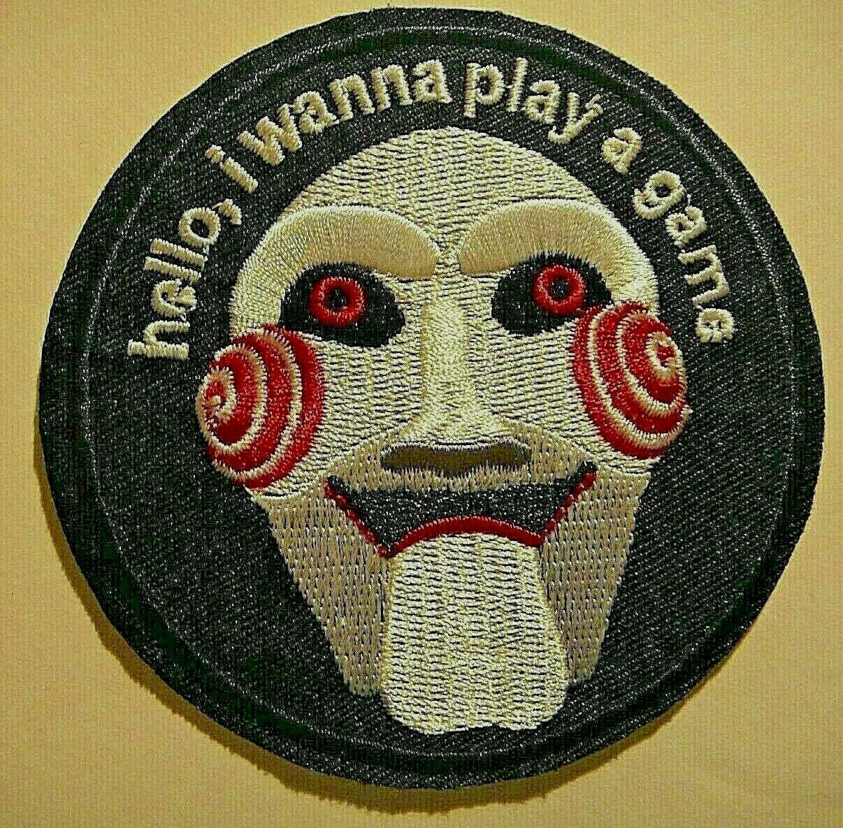 3 inches diameter,  a new Jigsaw "SAW" Hello, I wanna Play A Game embroidered patch. Sew on or iron on.

Please note we will always combine shipping on like items.  Any additional patch or pin will ship for 50 cent per item.  Any additional payment will be reimbursed to your Paypal account.  Thank You.