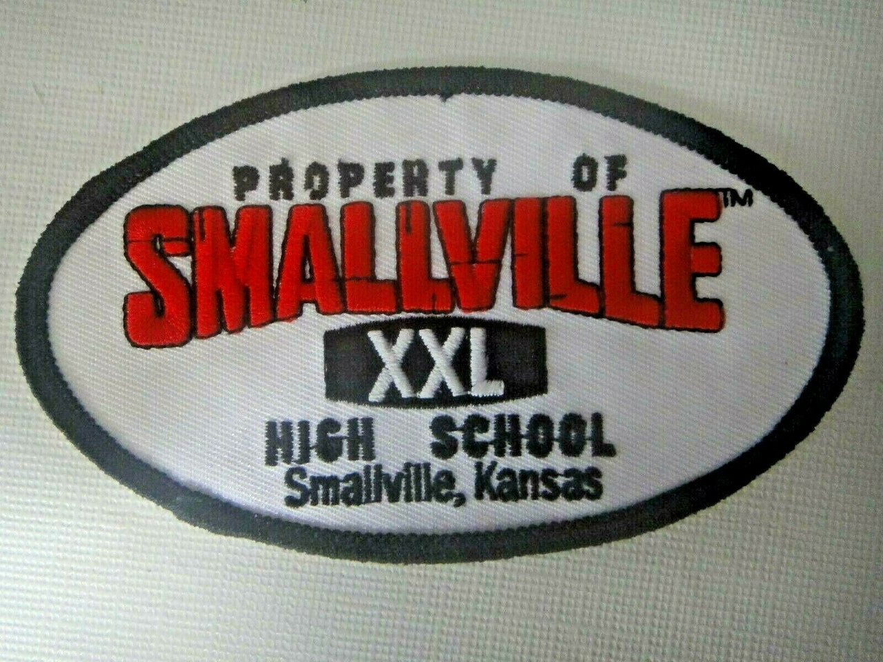 4.5 inches wide, a new DC Comics Smallville TV Series "Property of Smallville High School" Embroidered Patch. Sew on or iron on. 

Please note we will always combine shipping on like items.  Any additional patch or pin will ship for 50 cent per item.  Any additional payment will be reimbursed to your Paypal account.  Thank You.