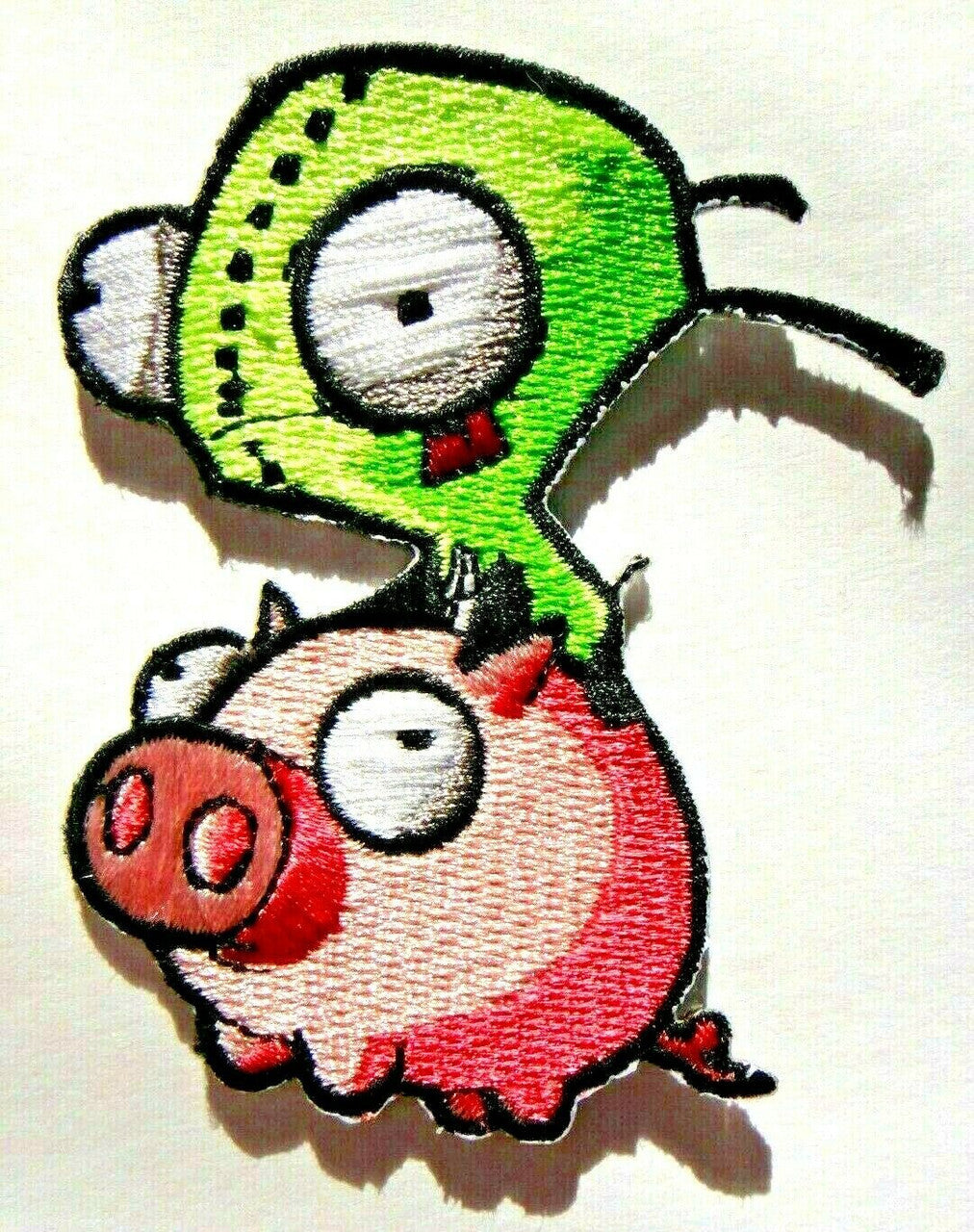 3 inches tall.  Invader Zim "Gir on a Pig" embroidered patch. Sew on or iron on. New.

Please note we will always combine shipping on like items.  Any additional patch or pin will ship for 50 cent per item.  Any additional payment will be reimbursed to your Paypal account.  Thank You.