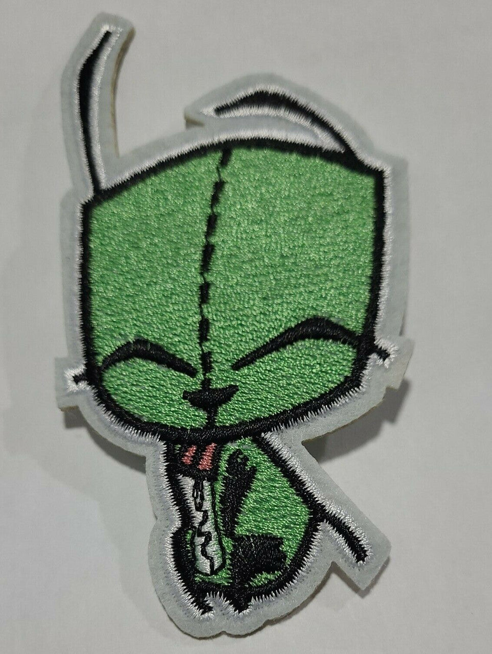 4. 3/4 inches tall,  a new GIR with his eyes closed embroidered patch.   Sew on or iron on. 
(Garbage-issue Information Retrieval) the dim witted robot from the cartoon series "Invader Zim" is featured on his own embroidered patch. New.

Please note we will always combine shipping on like items.  Any additional patch or pin will ship for 50 cent per item.  Any additional payment will be reimbursed to your Paypal account.  Thank You.