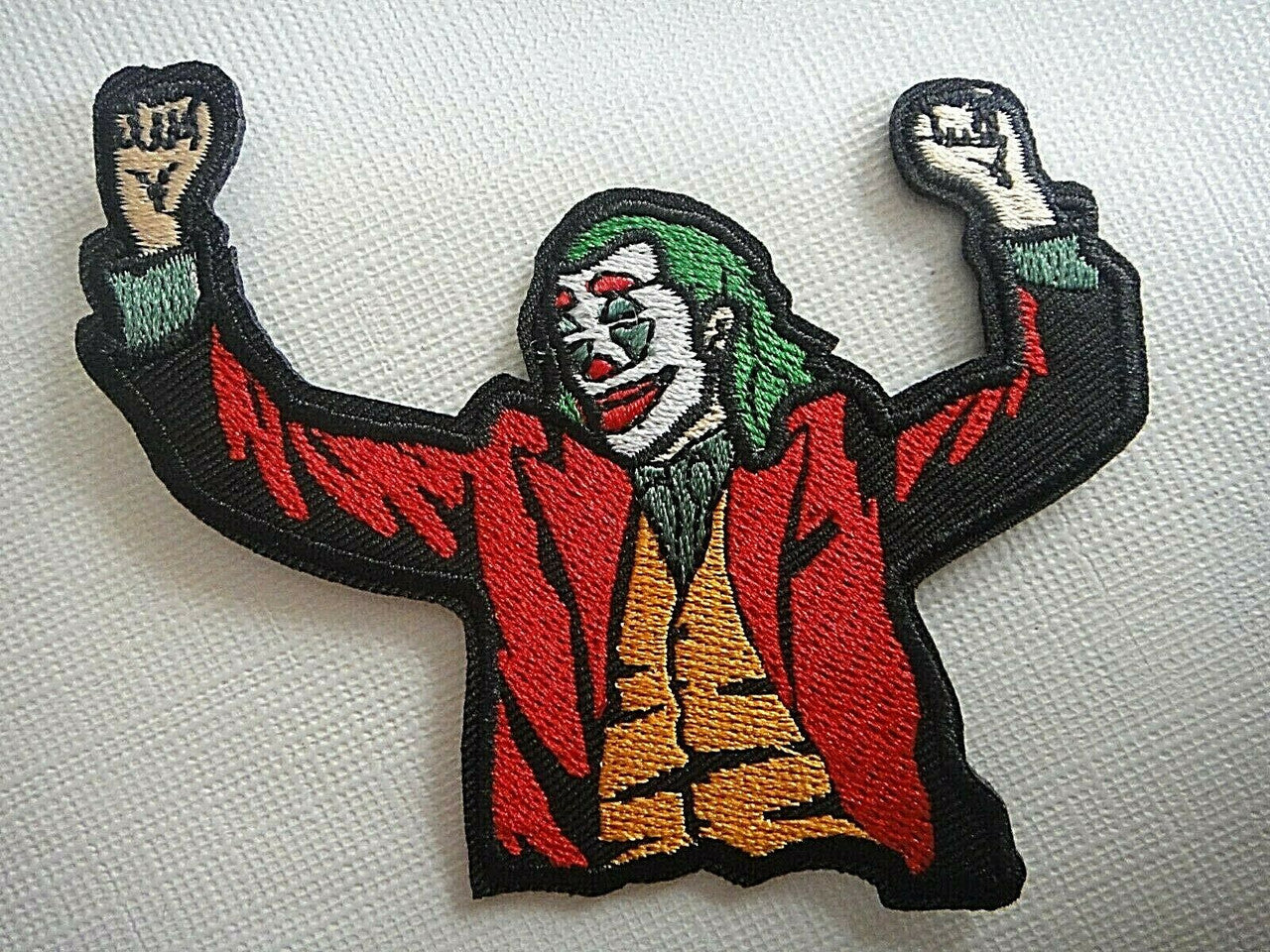 4 inches wide,  a new DC Comics The Joker Movie (Joaquin Phoenix)  embroidered patch.  The premier villain to the Batman franchise.  Sew or iron on. New. 

Please note we will always combine shipping on like items.  Any additional patch or pin will ship for 50 cent per item.  Any additional payment will be reimbursed to your Paypal account.  Thank You.