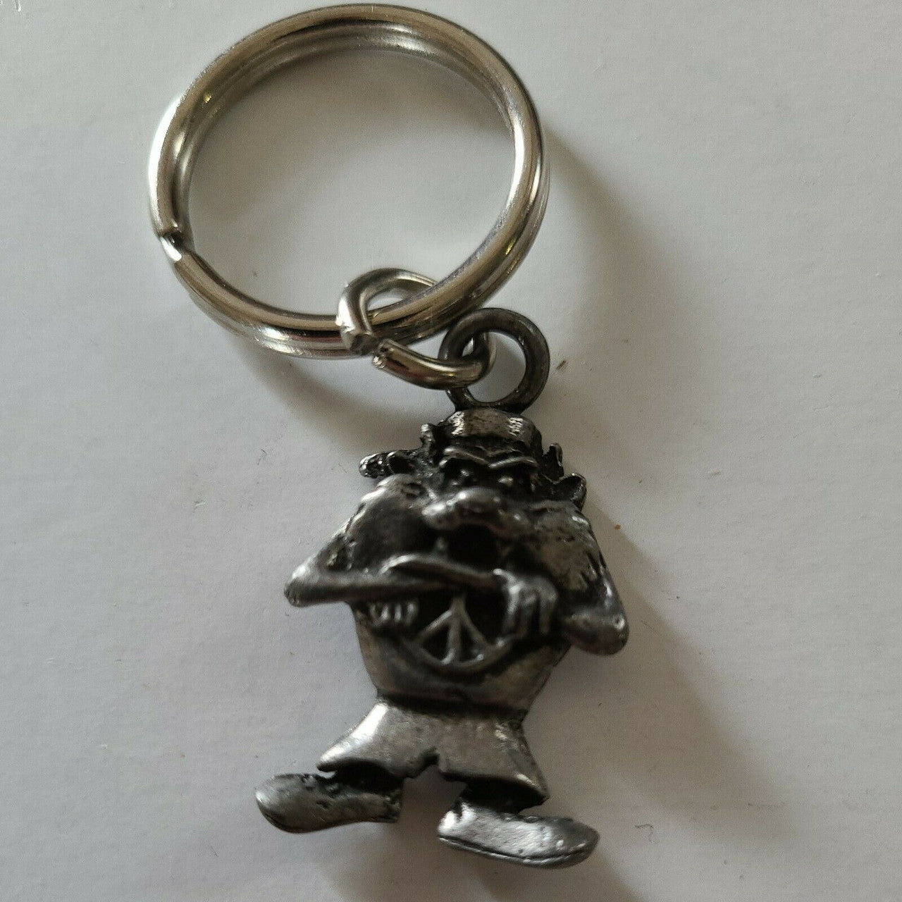 A new Looney Tunes Taz Pewter Embossed  Key Chain.  The ornament is 1. 1/2 inches tall but 3 inches tall overall. 

Please note we will always combine shipping on like items.  Any additional patch or pin will ship for 50 cent per item.  Any additional payment will be reimbursed to your Paypal account.  Thank You.