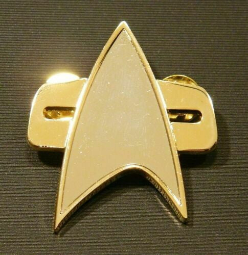 1. 3/4" x 2 inches tall,  a new Star Trek : Voyager full-size uniform cloisonne pin with single clutch back. This pin is a similar version of that worn on the ST: Voyager uniforms.   New.

Please note we will always combine shipping on like items.  Any additional patch or pin will ship for 75 cent per item.  Any additional payment will be reimbursed to your Paypal account.  Thank You.